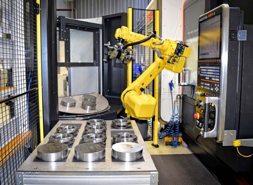 Lathe tending system modified to boost unattended production